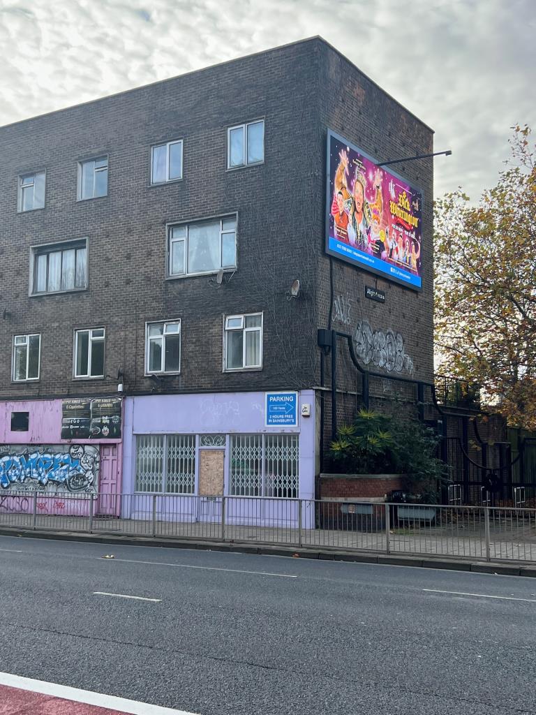 Lot: 5 - THREE STOREY FREEHOLD PROPERTY IN PROMINENT POSITION - External photo with digital advertising board on side